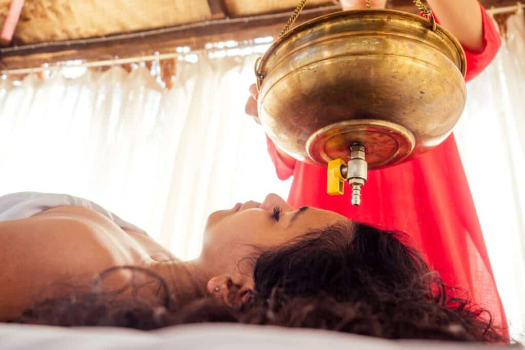 young woman doing healthcare indian traditional treatment in Ayurveda body constitution centre