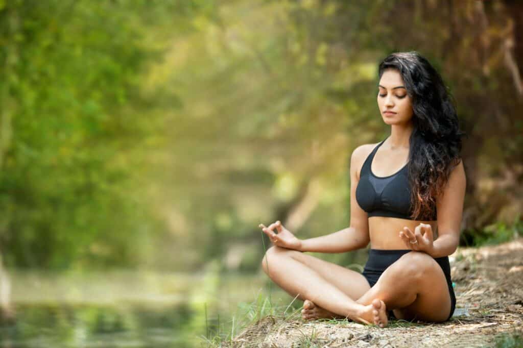 serene outdoor meditation by a young woman