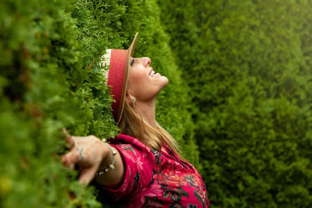 woman in red floral shirt lying on grass field